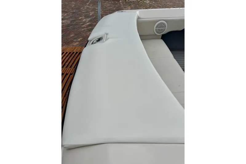 Slide: The Image of 1998 MasterCraft SportStar 19 boat interior with white upholstery and speaker detail. - 14