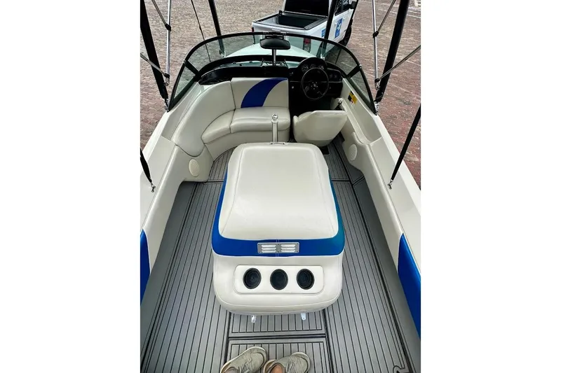 Slide: The Image of 1998 MasterCraft SportStar 19 boat interior with white and blue seating, steering wheel, and dashboard. - 16