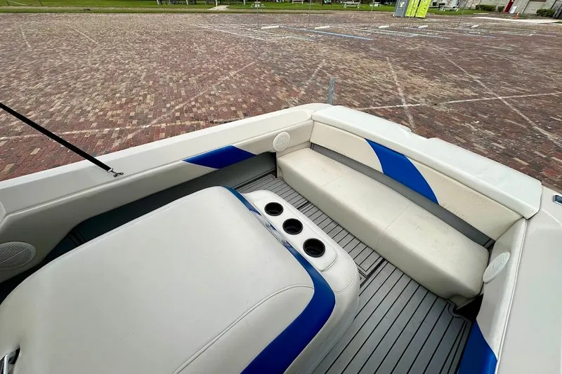 Slide: The Image of 1998 MasterCraft SportStar 19 boat interior with white and blue seating and cup holders. - 17