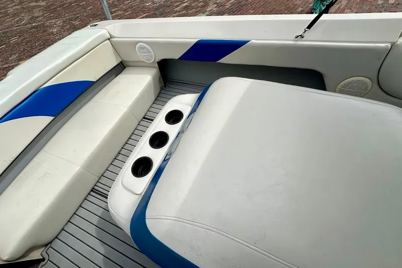 Slide: The Image of Interior of a 1998 MasterCraft SportStar 19 boat with blue and white seating. - 19