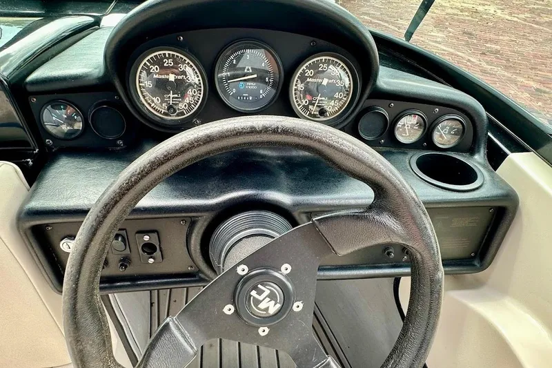 Slide: The Image of 1998 MasterCraft SportStar 19 dashboard with steering wheel and gauges. - 24