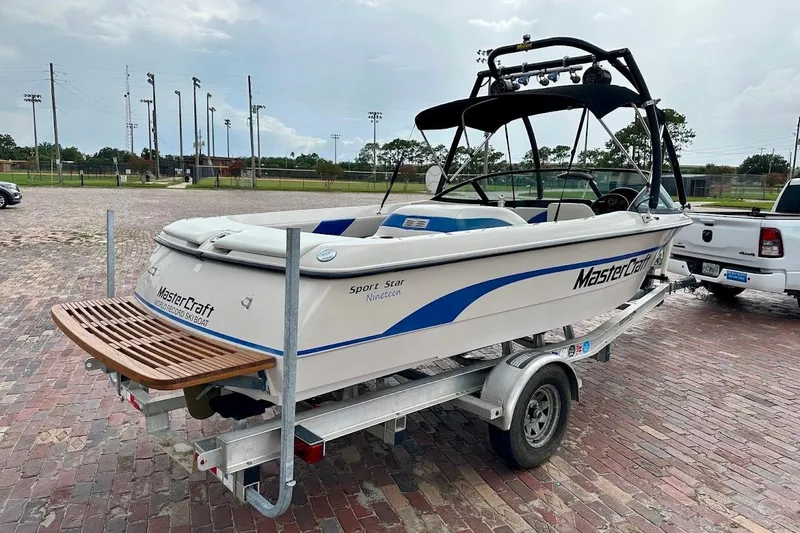 Slide: The Image of 1998 MasterCraft SportStar 19 boat on trailer, parked on brick pavement. - 3
