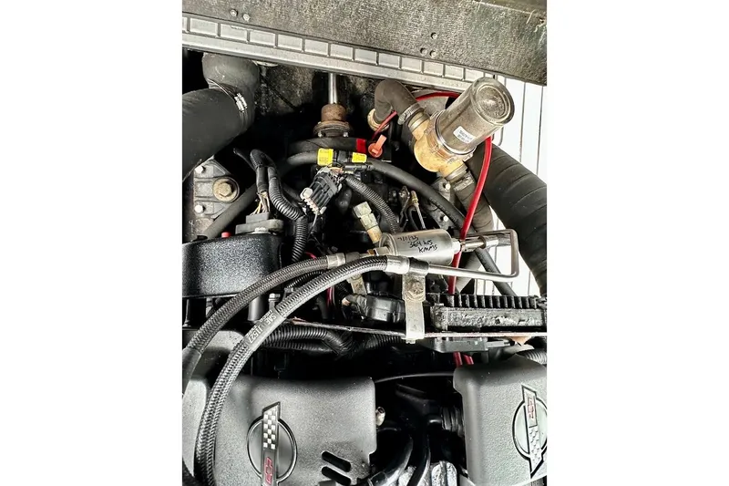 Slide: The Image of Engine components of a 1998 MasterCraft SportStar 19 boat, featuring hoses and wiring. - 31