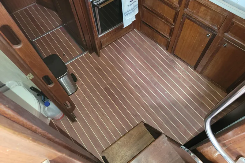 Slide: The Image of 1977 Hatteras 43 Double Cabin interior with wood flooring and cabinetry. - 22