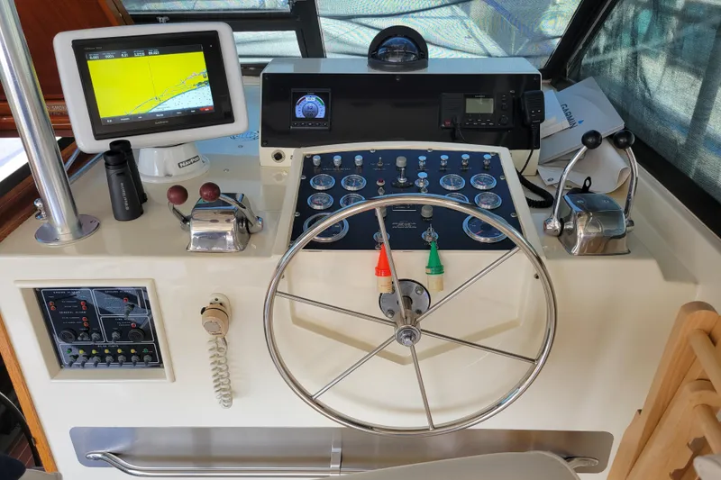 Slide: The Image of 1977 Hatteras 43 Double Cabin helm with navigation equipment and steering wheel. - 23