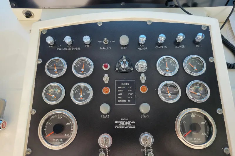 Slide: The Image of Control panel of a 1977 Hatteras 43 Double Cabin boat with gauges and switches. - 24