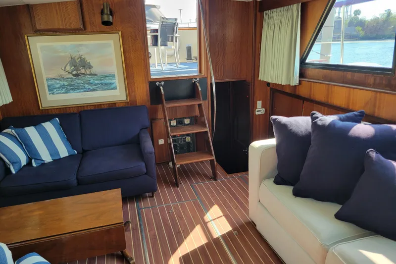 Slide: The Image of Interior of 1977 Hatteras 43 Double Cabin with nautical decor and comfortable seating. - 3