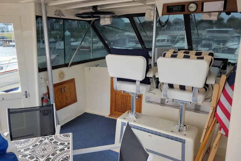 Slide: The Image of 1977 Hatteras 43 Double Cabin interior with helm chairs and nautical decor. - 30