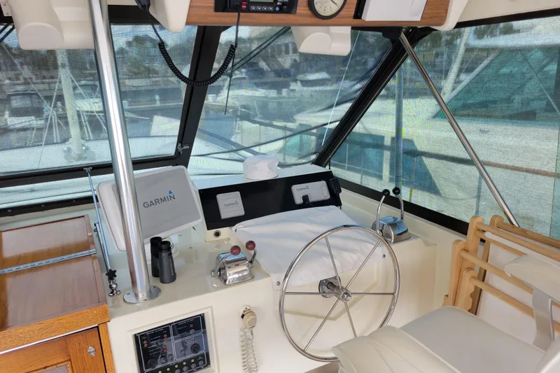 Slide: The Image of 1977 Hatteras 43 Double Cabin helm with Garmin navigation and classic steering wheel. - 32