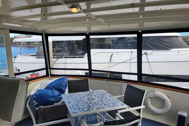 Slide: The Image of Interior view of a 1977 Hatteras 43 Double Cabin yacht with a table and chairs. - 34