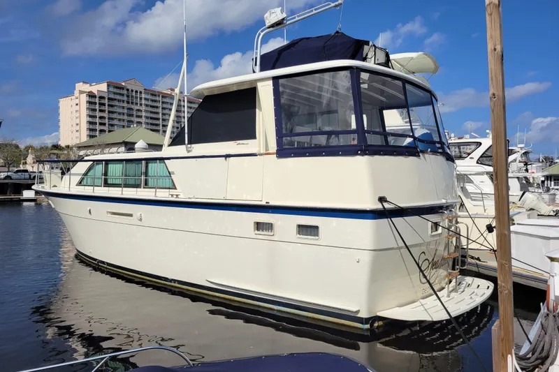 Slide: The Image of 1977 Hatteras 43 Double Cabin yacht docked at marina under blue sky. - 36