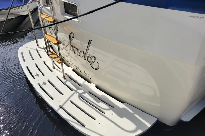Slide: The Image of 1977 Hatteras 43 Double Cabin yacht stern with ladder and swim platform. - 38