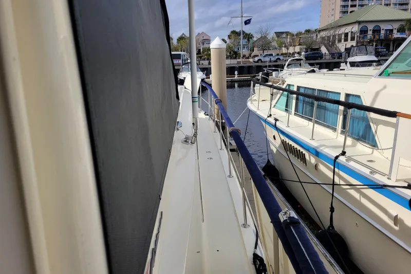Slide: The Image of 1977 Hatteras 43 Double Cabin yacht docked at marina, side view. - 40