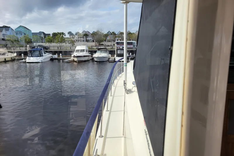Slide: The Image of 1977 Hatteras 43 Double Cabin docked at a marina with other boats. - 41