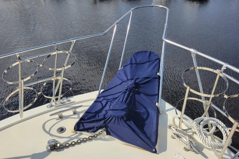 Slide: The Image of Bow of 1977 Hatteras 43 Double Cabin with blue cover and railing. - 42