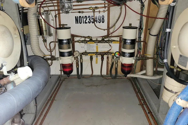 Slide: The Image of Engine room of a 1977 Hatteras 43 Double Cabin with mechanical components and wiring. - 47