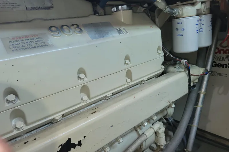 Slide: The Image of Engine compartment of a 1977 Hatteras 43 Double Cabin boat, featuring a 903 engine. - 49