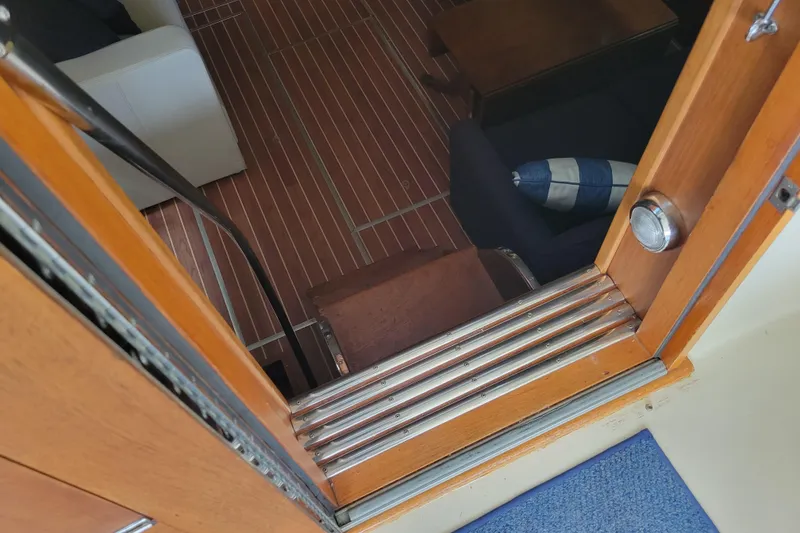 Slide: The Image of Interior view of 1977 Hatteras 43 Double Cabin, featuring wooden flooring and seating area. - 6