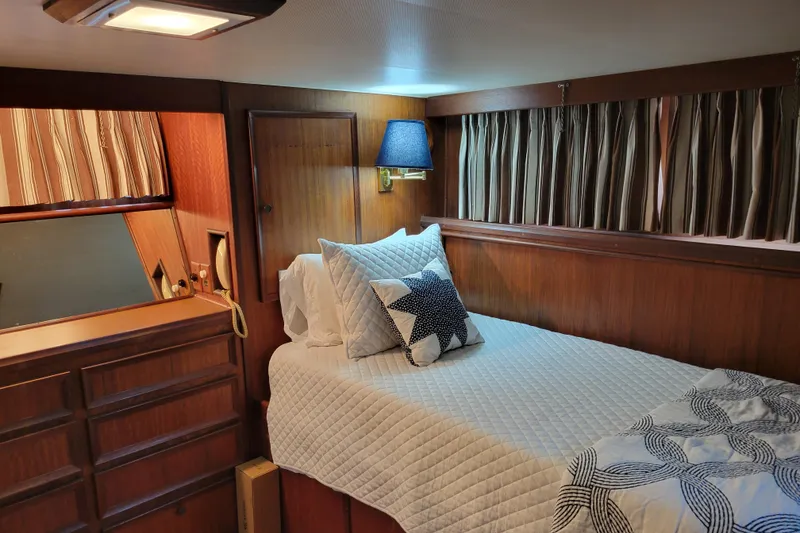 Slide: The Image of Cozy cabin interior of 1977 Hatteras 43 Double Cabin with bed and nautical decor. - 9