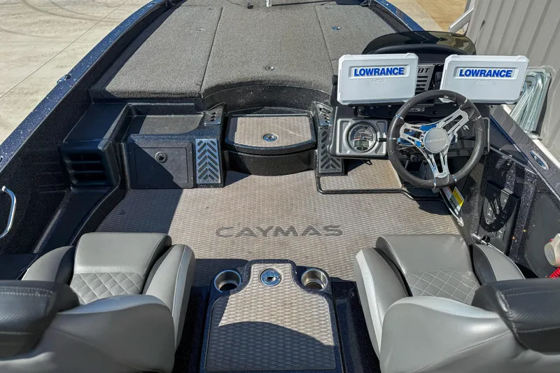 Slide: The Image of 2023 Caymas CX 21 PRO boat interior with dual Lowrance displays and steering wheel. - 11