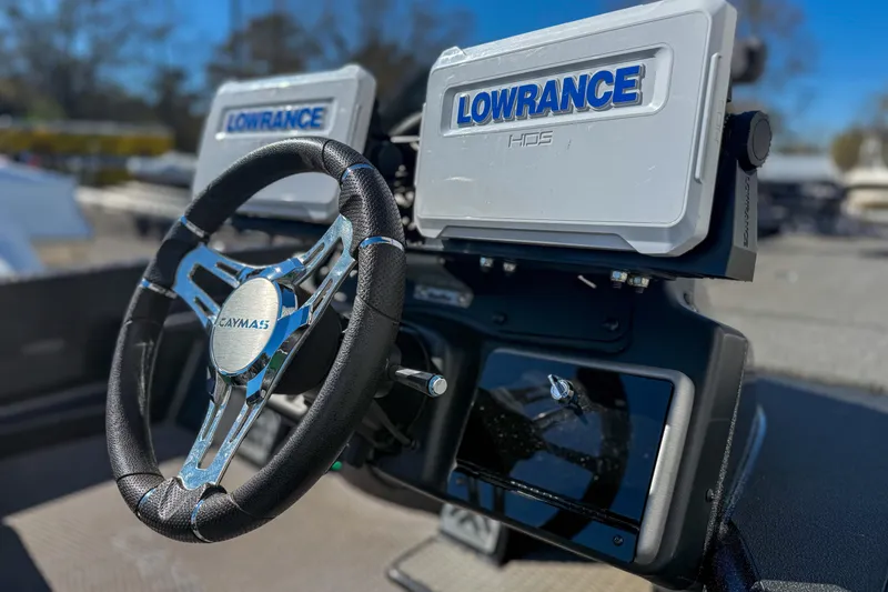 Slide: The Image of Steering wheel and Lowrance displays on 2023 Caymas CX 21 PRO boat dashboard. - 7