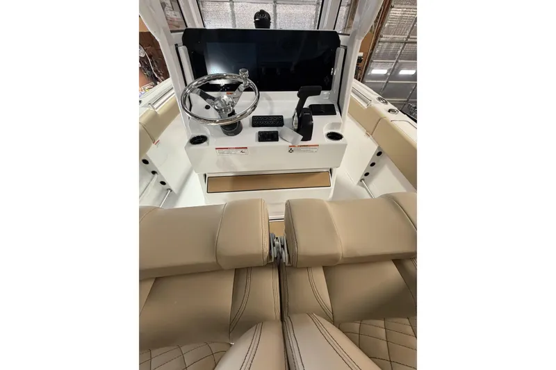 Slide: The Image of 2026 Sportsman Heritage 231 Center Console interior with steering wheel and beige seating. - 10