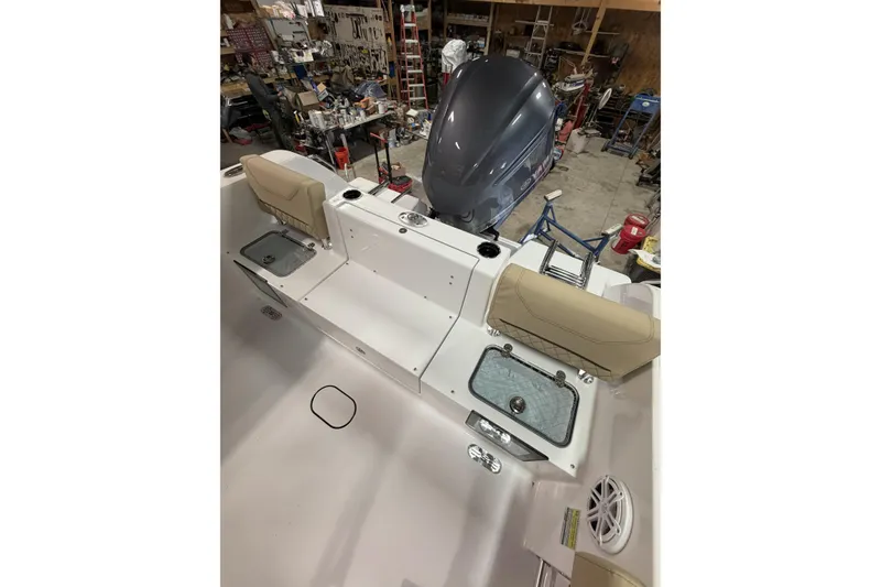 Slide: The Image of 2026 Sportsman Heritage 231 Center Console boat interior with seating and storage compartments. - 12