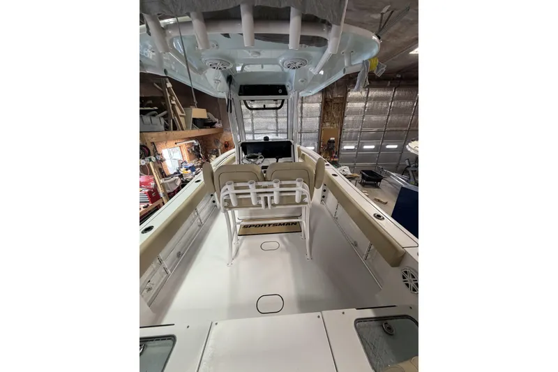 Slide: The Image of 2026 Sportsman Heritage 231 Center Console boat interior in a garage setting. - 14