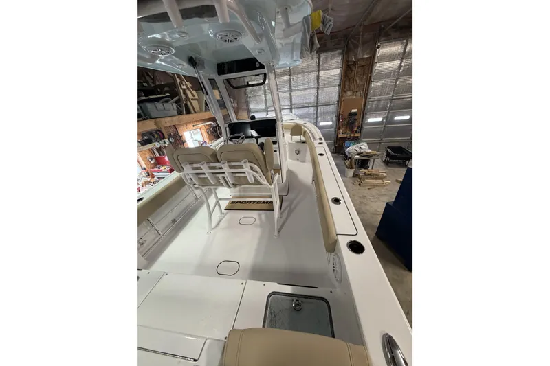 Slide: The Image of 2026 Sportsman Heritage 231 Center Console boat interior in a garage setting. - 16