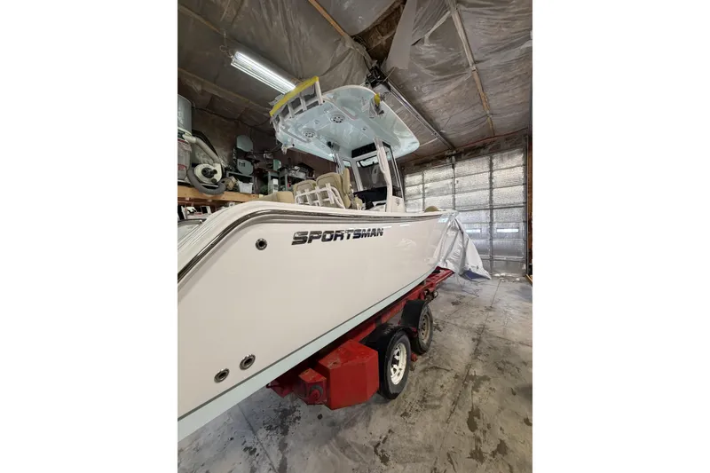 Slide: The Image of 2026 Sportsman Heritage 231 Center Console boat in a garage on a trailer. - 3