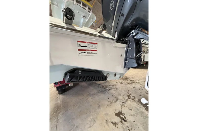 Slide: The Image of 2026 Sportsman Heritage 231 Center Console boat's rear view in a garage setting. - 4