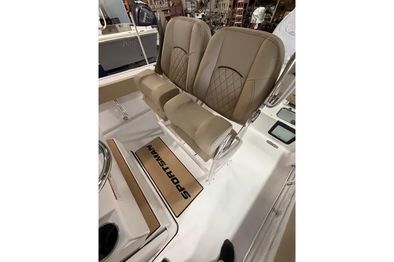 Slide: The Image of 2026 Sportsman Heritage 231 Center Console boat interior with tan seating and logo mat. - 8
