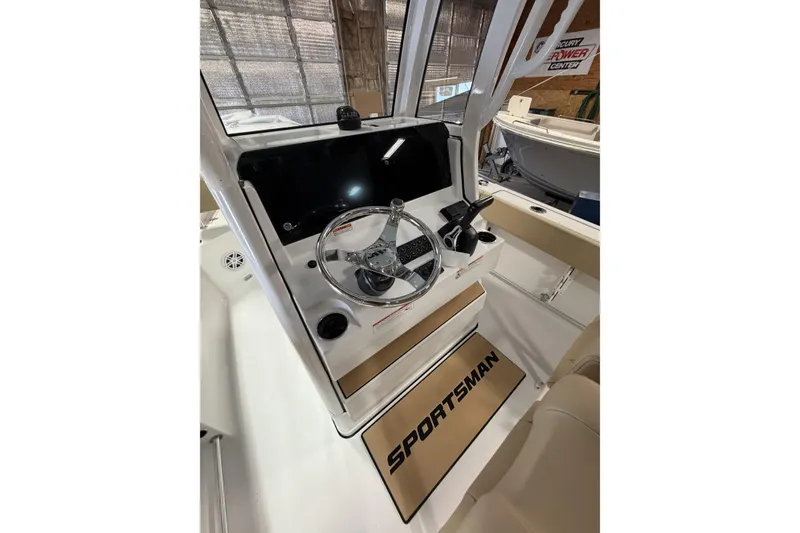 Slide: The Image of 2026 Sportsman Heritage 231 Center Console boat interior with steering wheel and dashboard. - 9