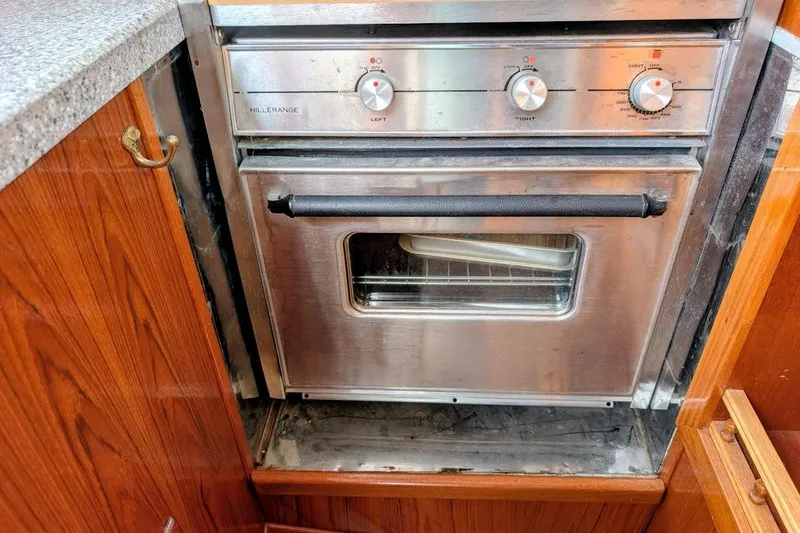 Slide: The Image of Stainless steel oven in 1980 Island Trader 38 yacht kitchen, surrounded by wooden cabinetry. - 14