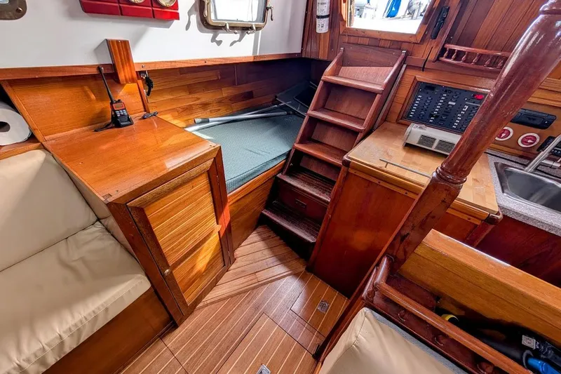 Slide: The Image of Interior of 1980 Island Trader 38 sailboat with wooden cabinetry and compact living space. - 18