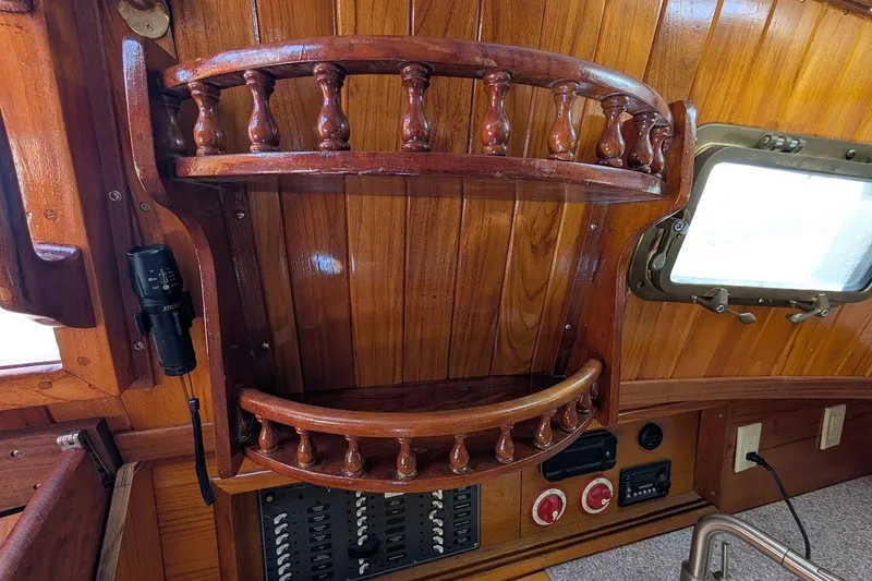 Slide: The Image of Wooden interior of 1980 Island Trader 38 boat with shelves and control panel. - 22