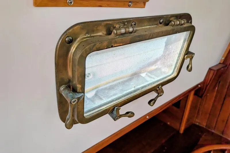 Slide: The Image of Brass porthole window on 1980 Island Trader 38 sailboat interior. - 23