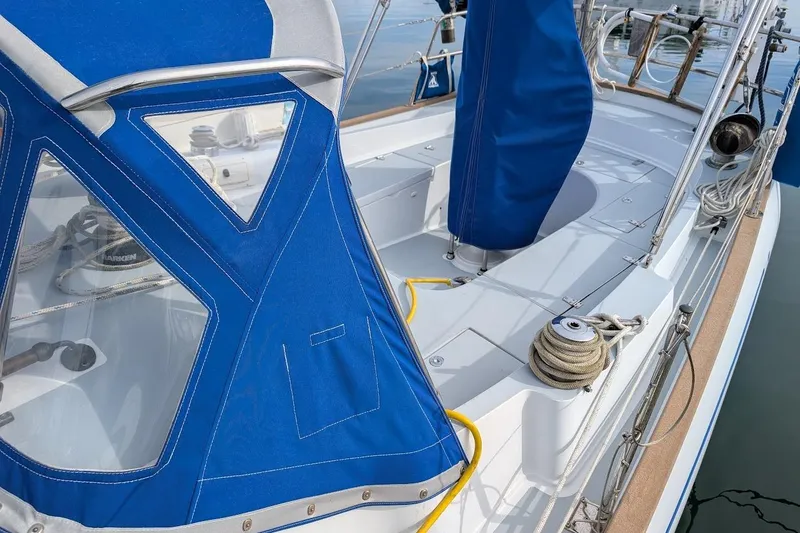 Slide: The Image of 1980 Island Trader 38 sailboat deck with blue canvas cover and rigging details. - 24