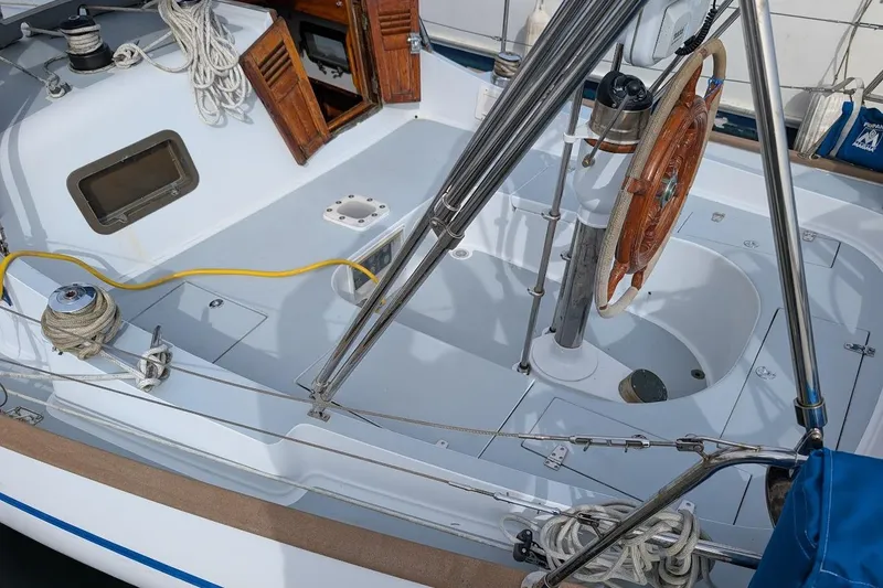 Slide: The Image of 1980 Island Trader 38 sailboat cockpit with wooden wheel and rigging details. - 31