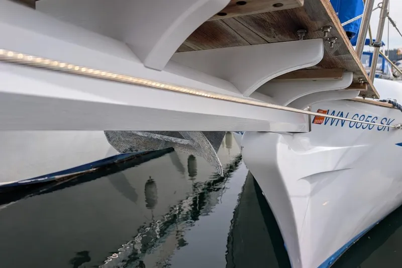 Slide: The Image of 1980 Island Trader 38 sailboat with visible anchor and hull details in marina. - 41