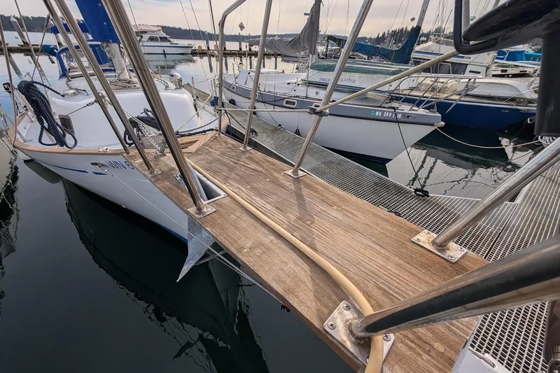 Slide: The Image of 1980 Island Trader 38 sailboat docked at marina with wooden gangway. - 42