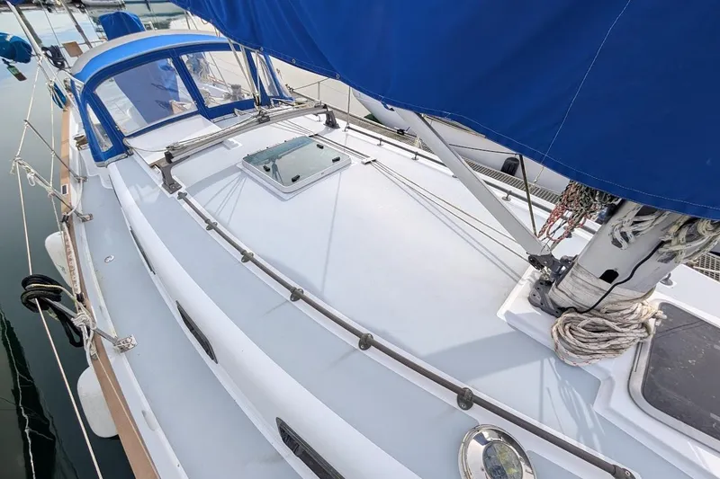 Slide: The Image of 1980 Island Trader 38 sailboat deck with blue canopy and rigging. - 43