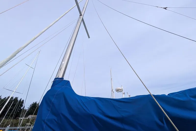 Slide: The Image of Sailboat mast and rigging of 1980 Island Trader 38, covered with blue tarp. - 44