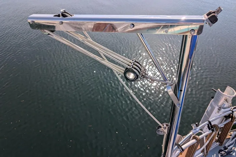 Slide: The Image of Stainless steel rigging on 1980 Island Trader 37 sailboat, reflecting sunlight on water. - 46
