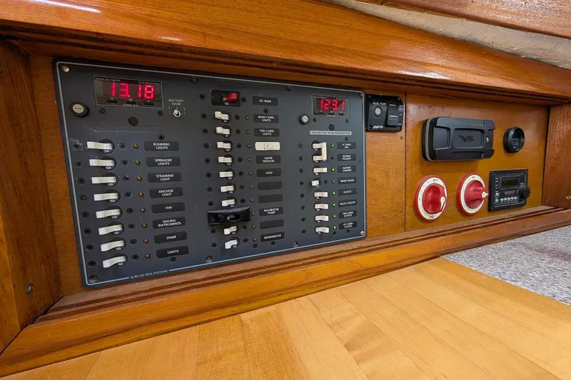 Slide: The Image of Electrical control panel on a 1980 Island Trader 38 sailboat, featuring switches and voltage displays. - 47
