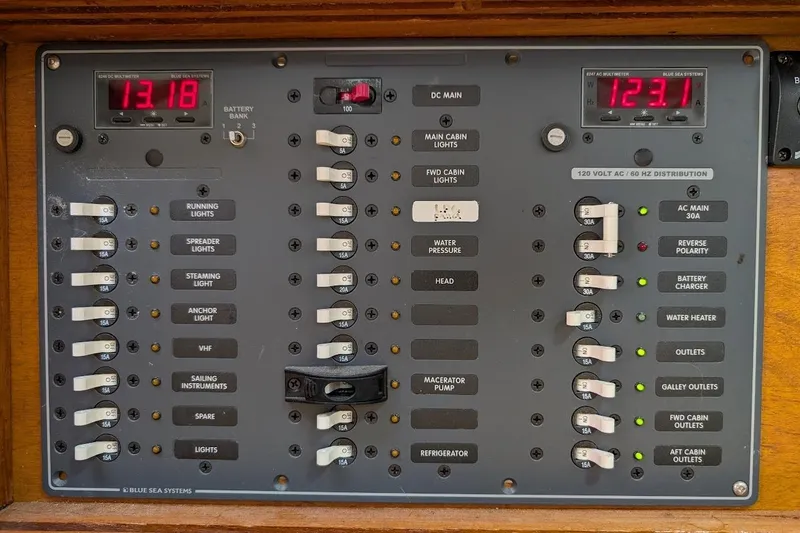 Slide: The Image of Electrical control panel on a 1980 Island Trader 38 boat, featuring various switches and meters. - 48