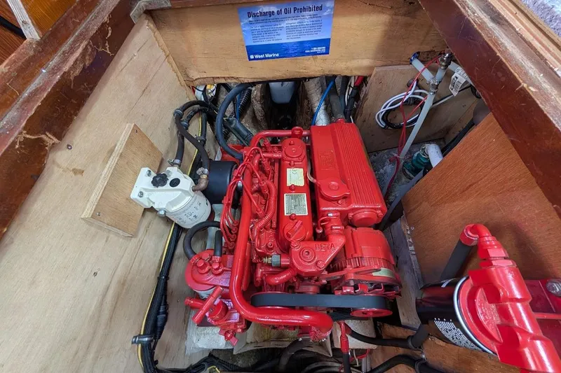 Slide: The Image of Engine compartment of a 1980 Island Trader 38 sailboat with a red Beta Marine engine. - 50