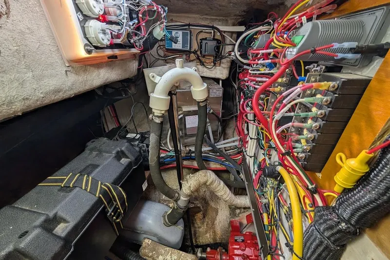 Slide: The Image of Engine room of a 1980 Island Trader 38, showcasing wiring and mechanical components. - 51