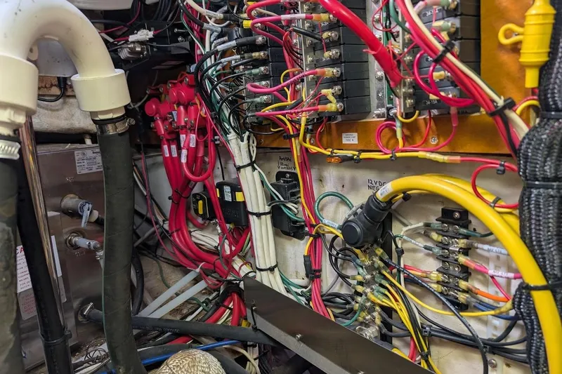 Slide: The Image of Electrical wiring system inside a 1980 Island Trader 38 boat, featuring colorful cables and connectors. - 52