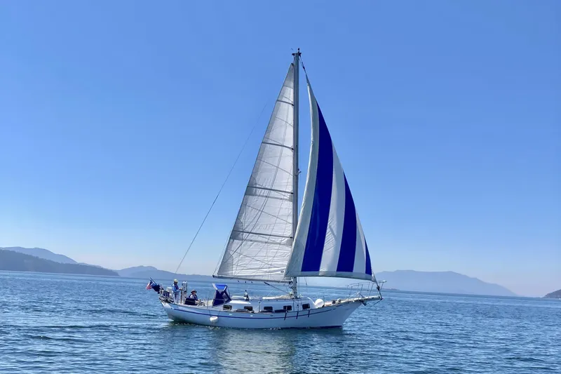 Slide: The Image of Sailboat Island Trader 37 from 1980 cruising on open water under clear blue skies. - 54